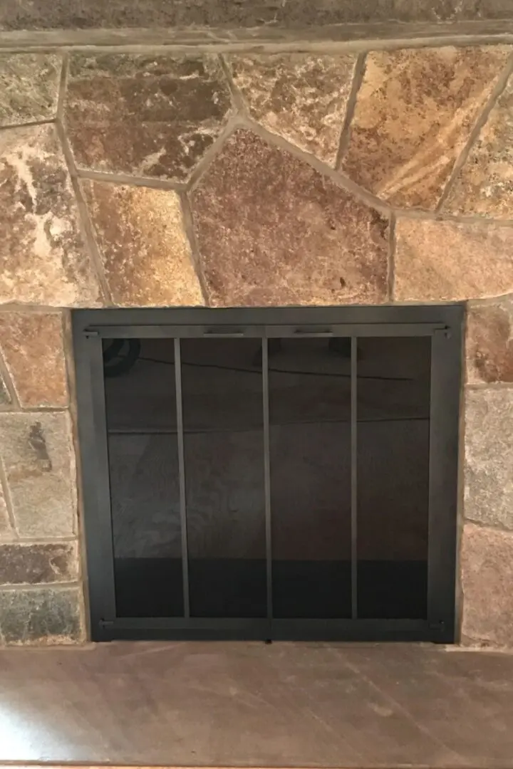 Fireplace in a home closed with a metal mesh